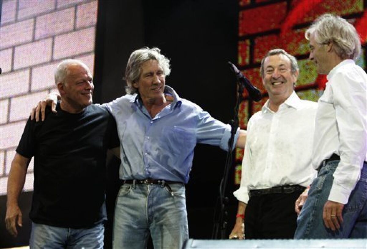 FILE - This is Saturday July 2, 2005 file photo of Pink Floyd's Dave Gilmour, left, Roger Waters, second left, Nick Mason, second right, and Rick Wright, at the end of their set at the Live 8 concert in Hyde Park, London. In a victory for the concept album, Britain's High Court on Thursday March 11, 2010 ordered record company EMI Group Ltd. to stop selling downloads of Pink Floyd tracks individually rather than as part of the band's original records. The rock group sued the music label, saying its contract prohibited selling the tracks "unbundled" from their original album setting. (AP Photo/Lefteris Pitarakis, File)