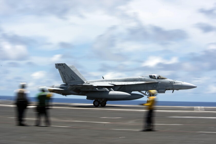 An F/A-18E Super Hornet practices a maneuver June 10 on the flight deck of the Ronald Reagan in the Philippine Sea.