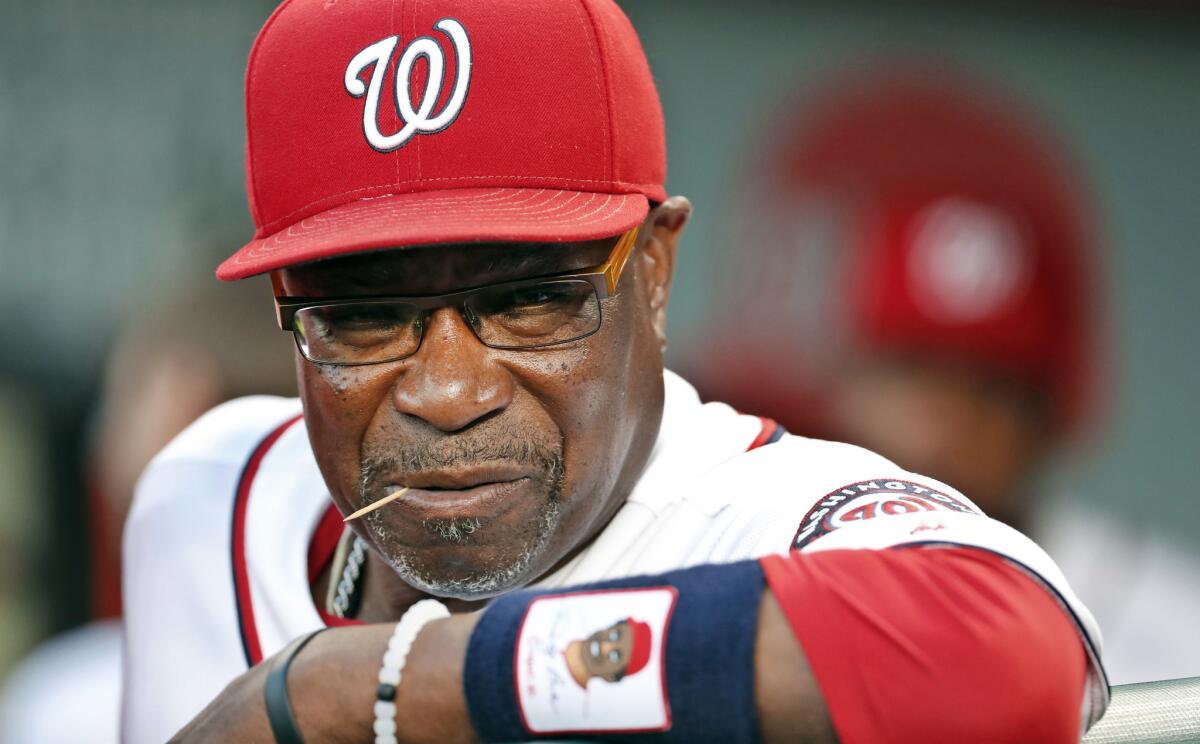 In this Sept. 13, 2016, file photo, Washington Nationals manager Dusty Baker pauses in the dugout before a baseball game against the New York Mets at Nationals Park in Washington.