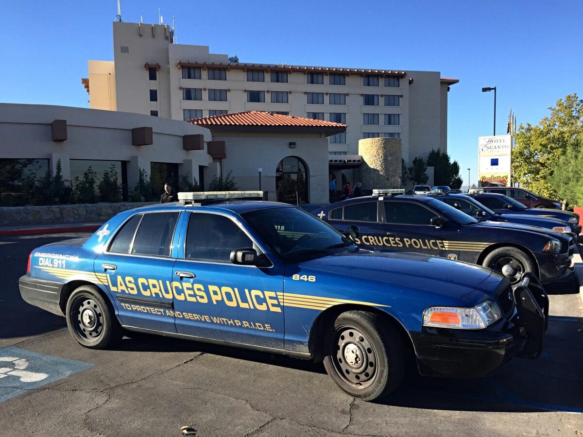 Las Cruces police investigate a shooting scene at the Hotel Encanto in Las Cruces, N.M., on Oct. 28. A Santa Fe County sheriff's deputy is thought to have shot and killed a fellow deputy at the hotel.