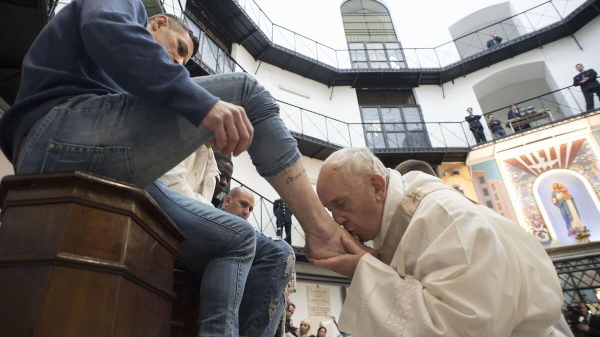 In a Holy Thursday ritual, Pope Francis kisses the feet of an inmate at the Regina Coeli prison in Rome on March 29.