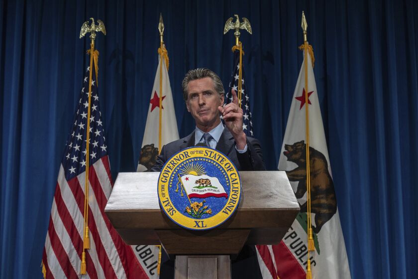 California Gov. Gavin Newsom answers questions from reporters after delivering his revised budget proposal at a press conference on Friday, May 14, 2021 in Sacramento, Calif. Gov. Newsom proposed a $268 billion state budget that is one-third larger than the state's current spending plan, fueled by surging state tax revenues and federal stimulus money. (Renee C. Byer/The Sacramento Bee via AP)