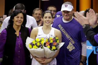 Washington's Kelsey Plum, center, walks onto the court with her parents Katie and Jim Plum for Senior Night after setting the NCAA scoring record.