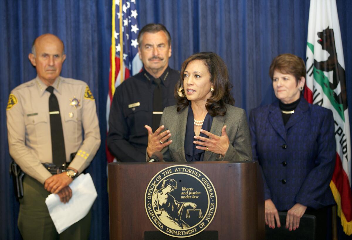 California's attorney general Kamala Harris, at podium, addresses the issue of inmate recidivism during a news conference in Los Angeles.