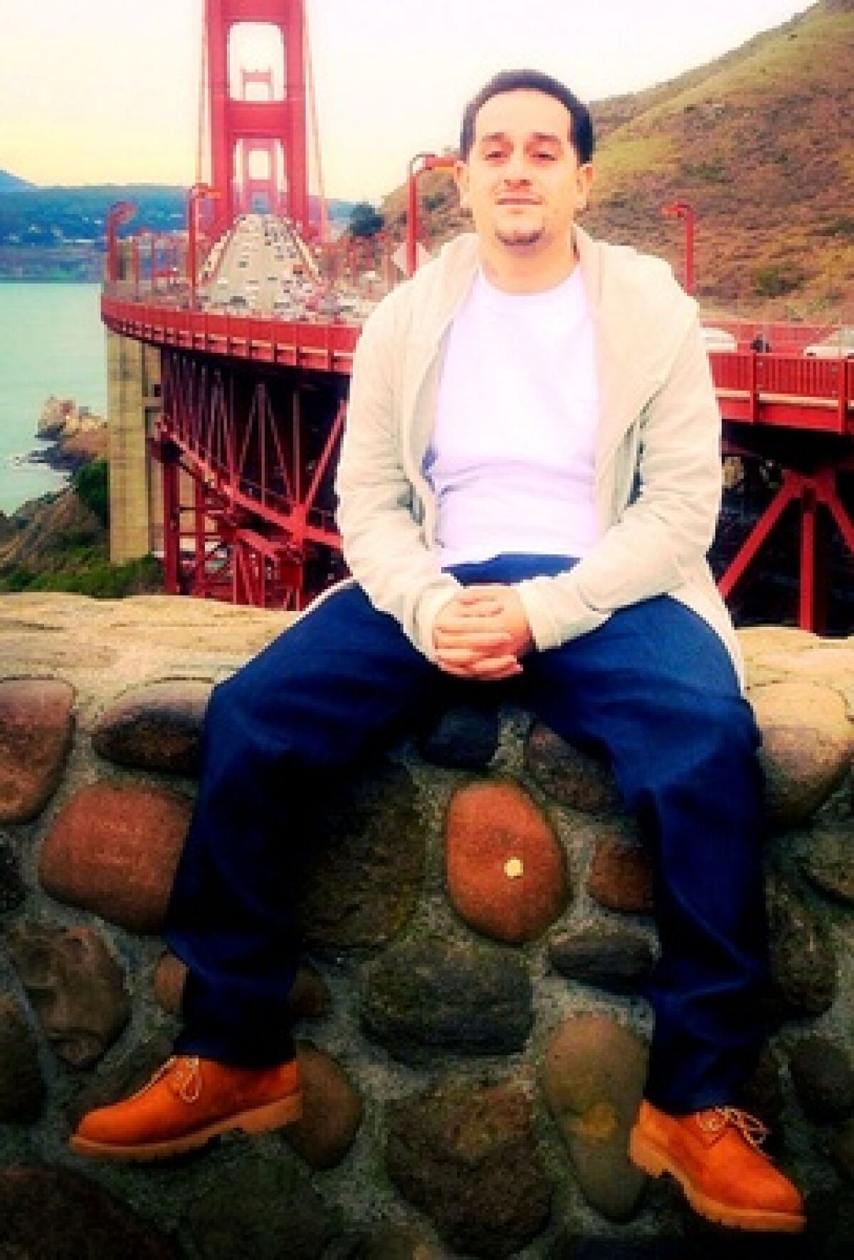 Robert Calderon poses in front of the Golden Gate Bridge 