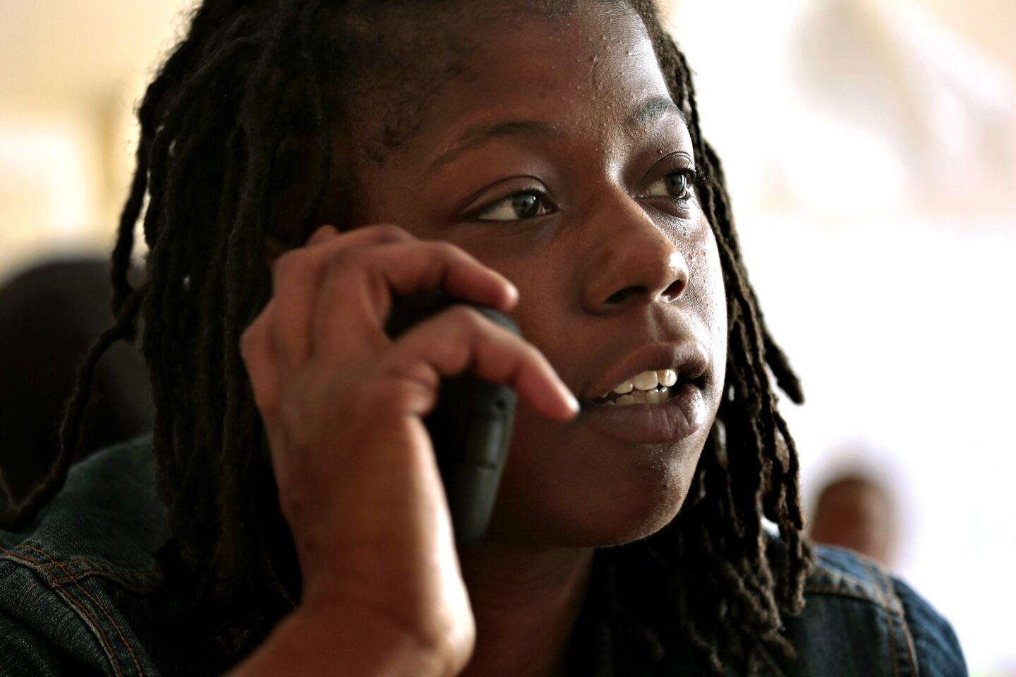 Working from the New York Communities for Change office in Brooklyn on Aug. 27, Naquasia LeGrand calls fast-food restaurant workers to encourage them to take part in a protest two days later.