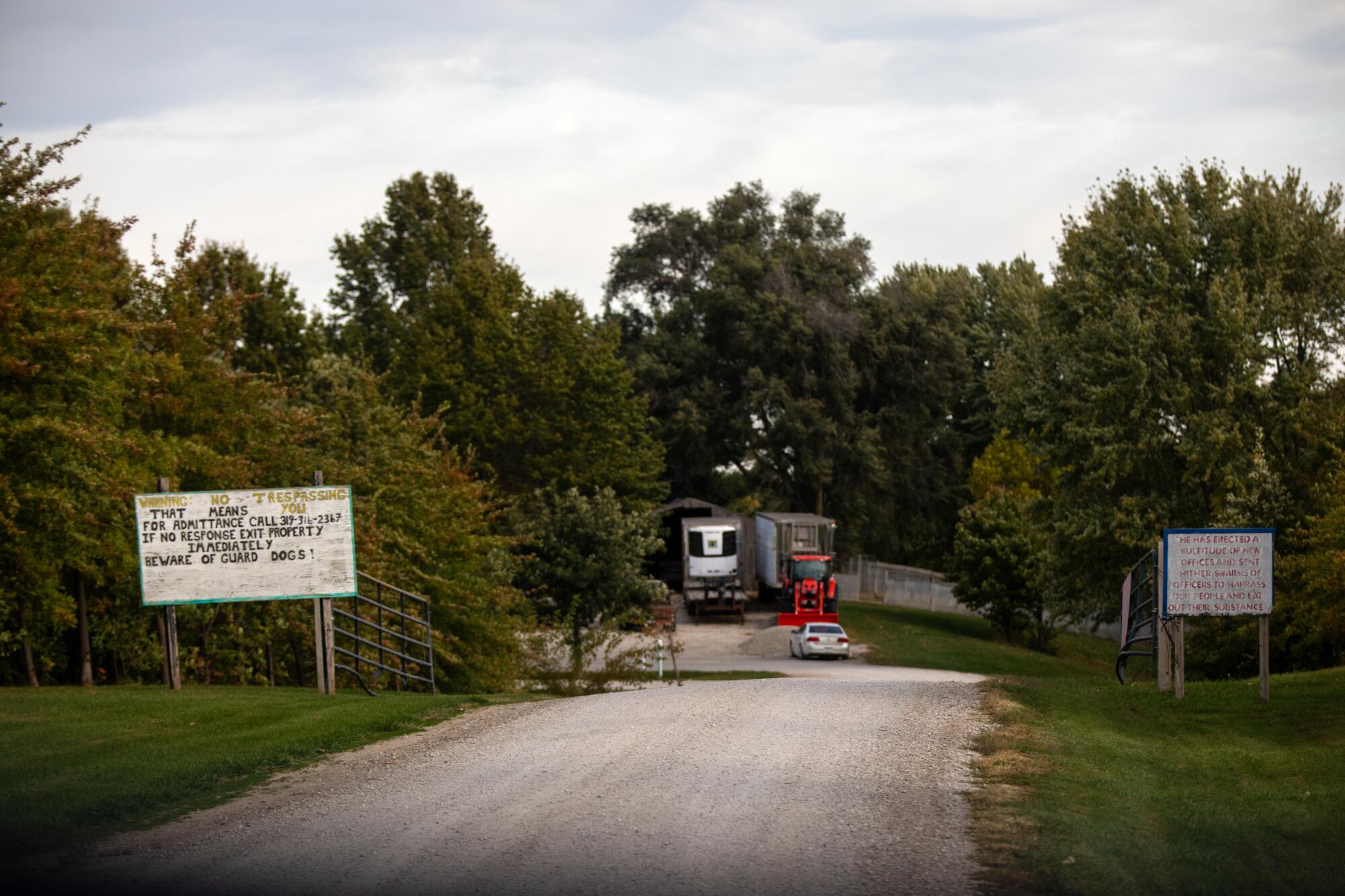 Warning signs flank a road in a rural area