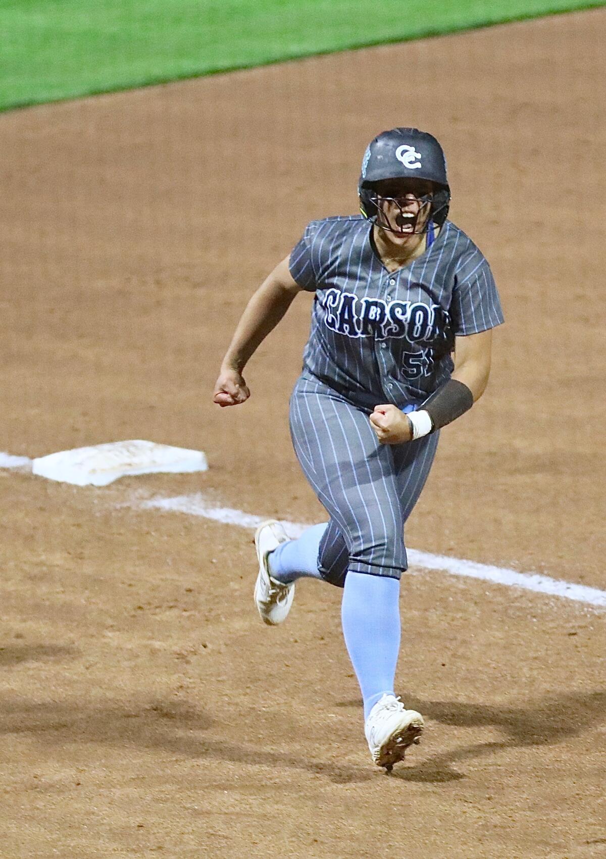 Carson's Alana Langford rounds third base after hitting a solo homer in the 14th inning of the City Open Division final.