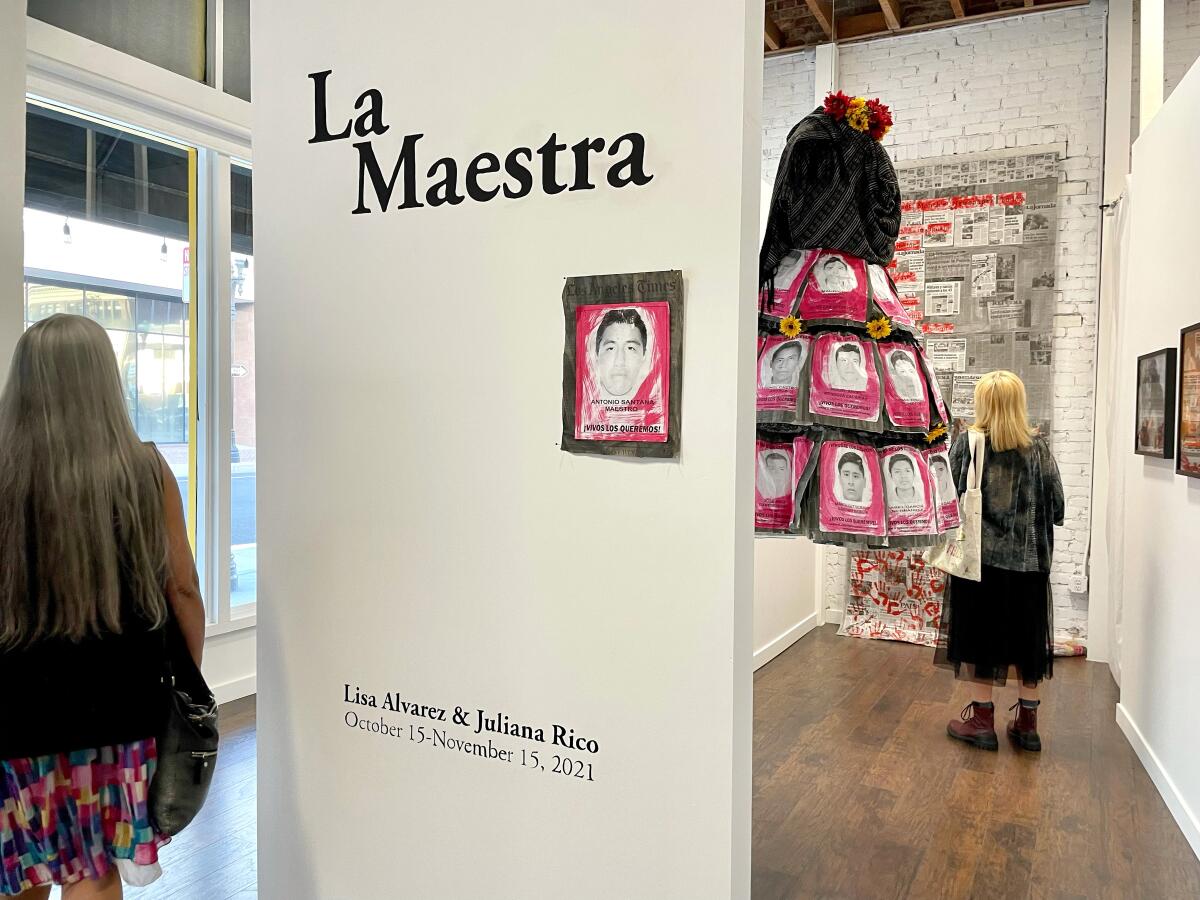 From left to right: Local artists Lisa Alvarez and Carla Zarate Suarez visiting La Maestra exhibition.