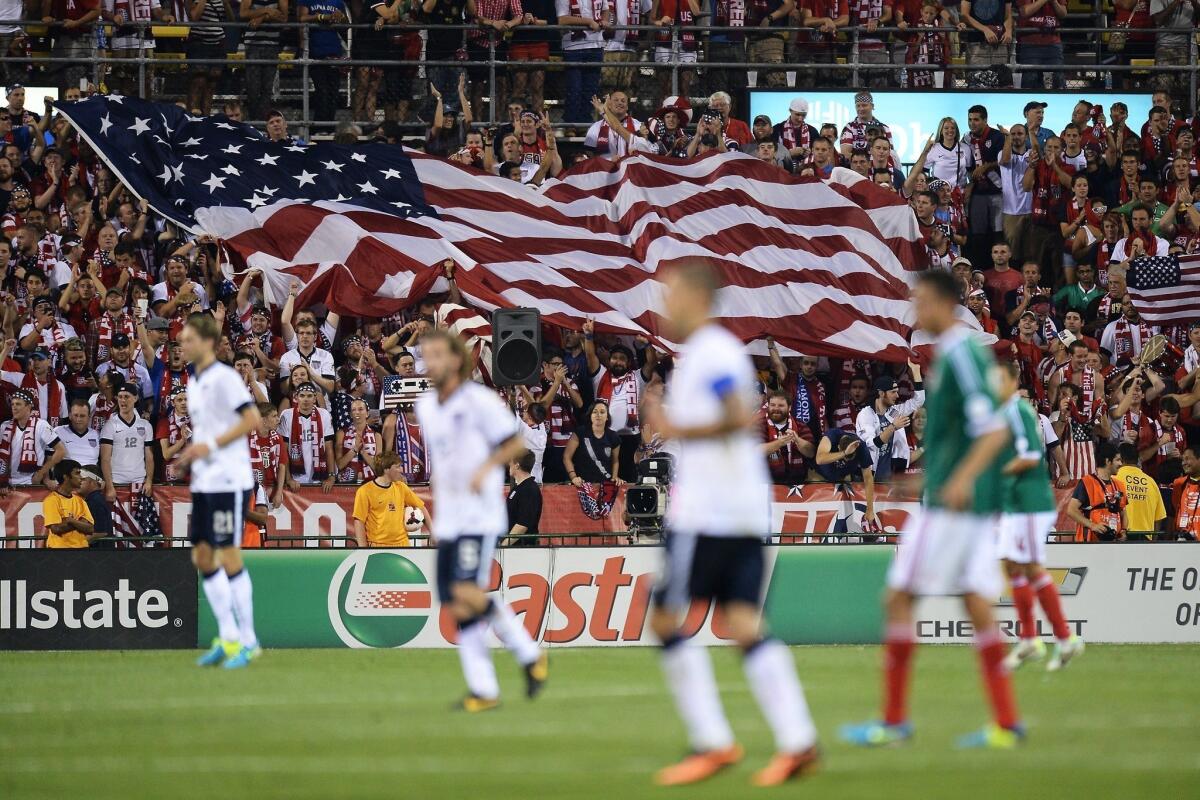 Fans unfurl a large U.S. flag after the U.S. men's national team scored their second goal against Mexico on Saturday.