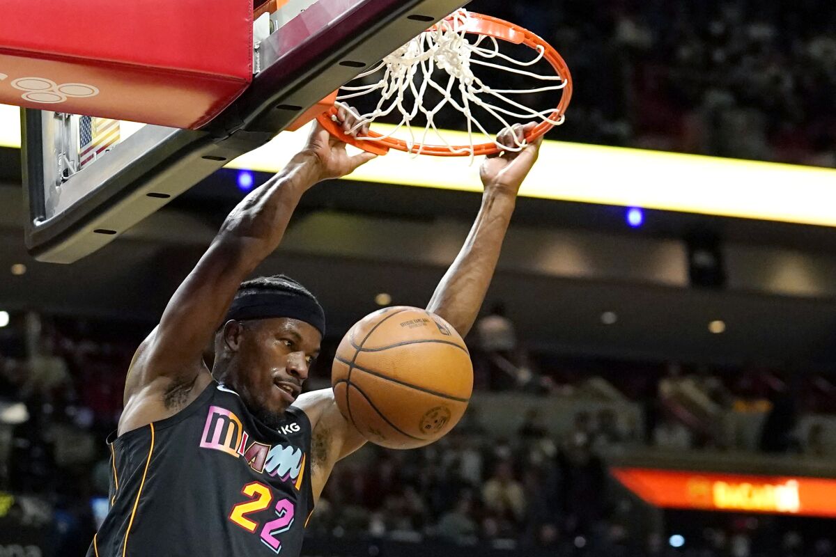 Miami's Jimmy Butler dunks during the first half Jan. 28, 2022.