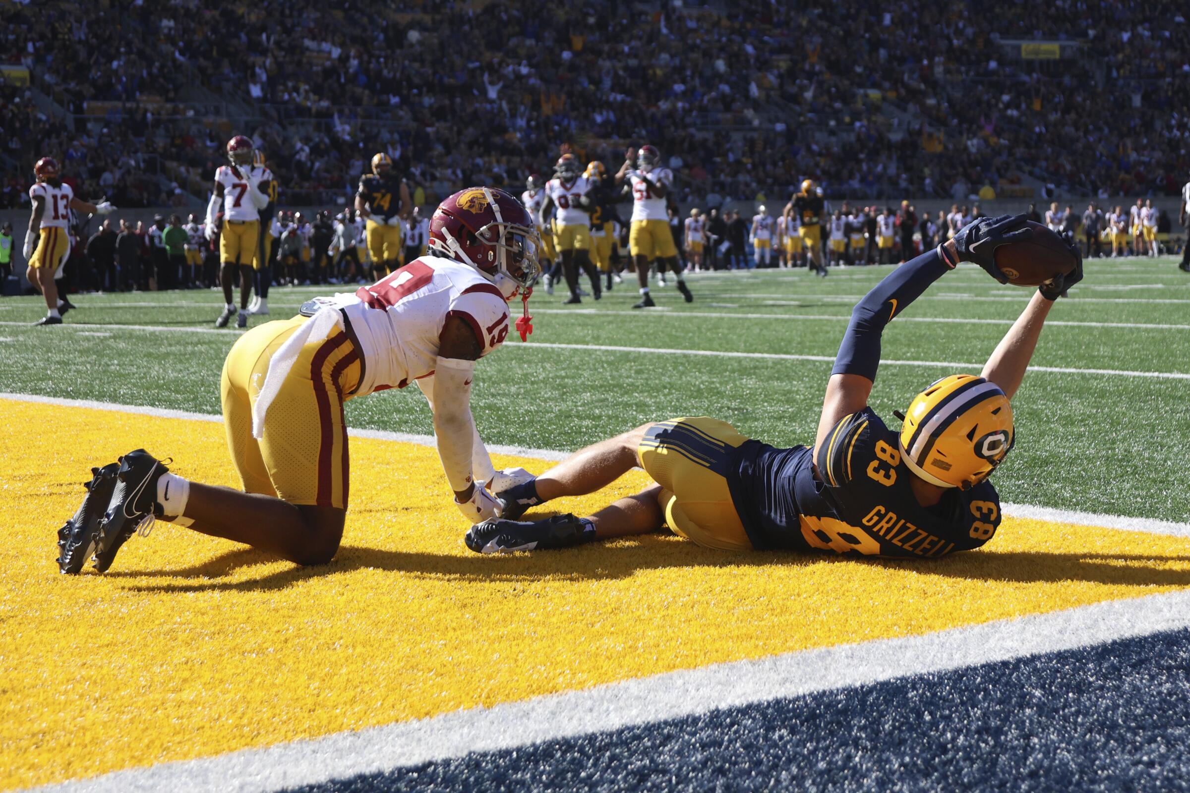 Cal wide receiver Trond Grizzell, right, celebrates after scoring a touchdown over USC safety Jaylin Smith.