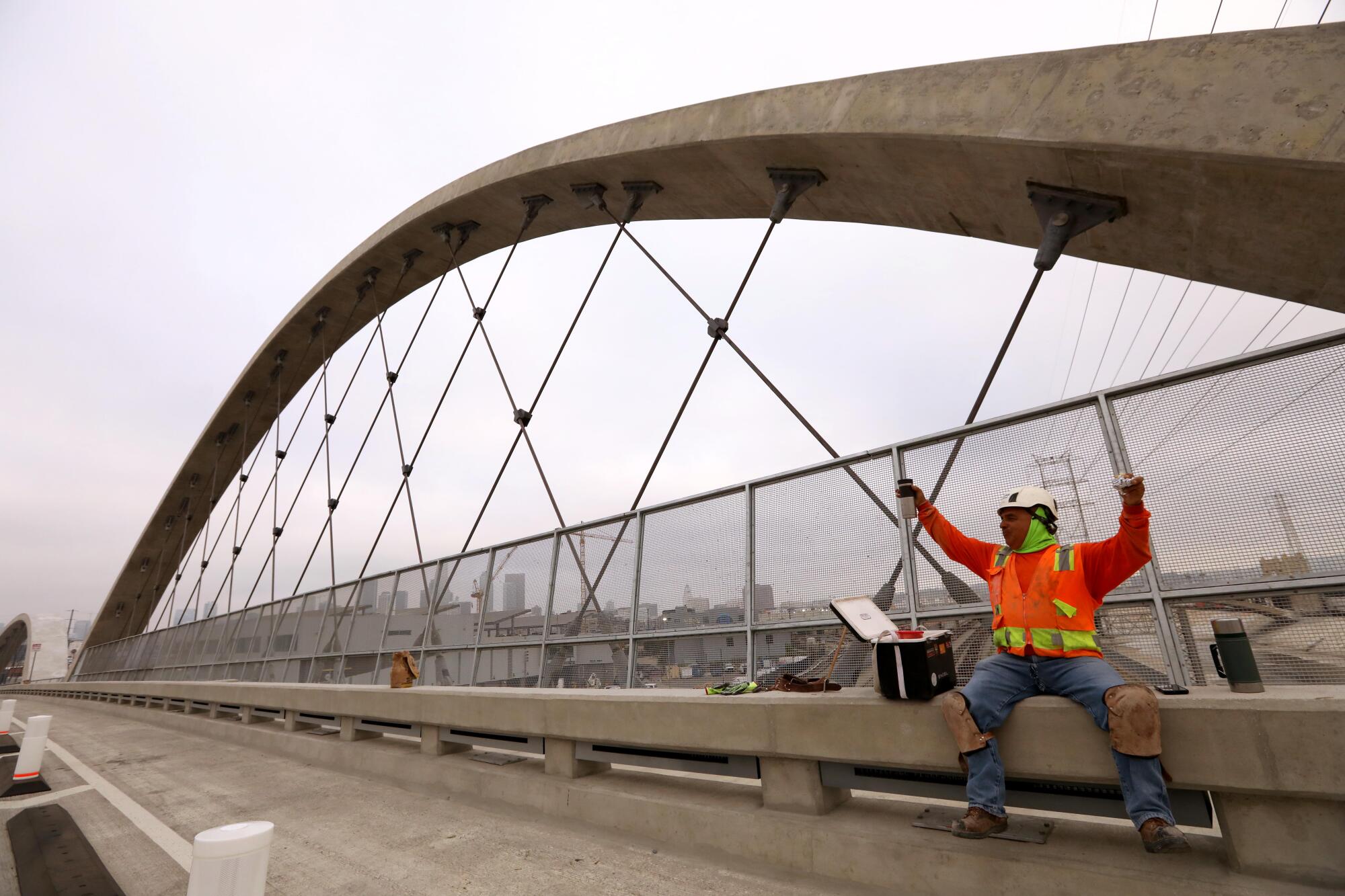 Cement mason Jose Flores celebrates the completion of the new 6th Street Viaduct.