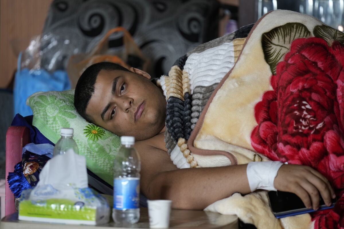 Hussein Maytham lies on a couch in his home in Muqdadiyah, Iraq
