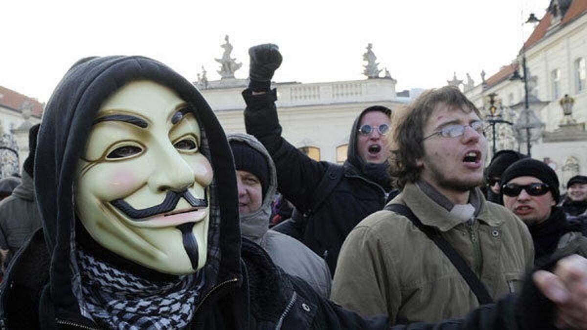 A protester wearing a Guy Fawkes mask, a symbol adopted by the hacker group Anonymous, takes part in a demonstration against the controversial Anti-Counterfeiting Trade Agreement (ACTA) in front of the Presidential Palace in Warsaw.