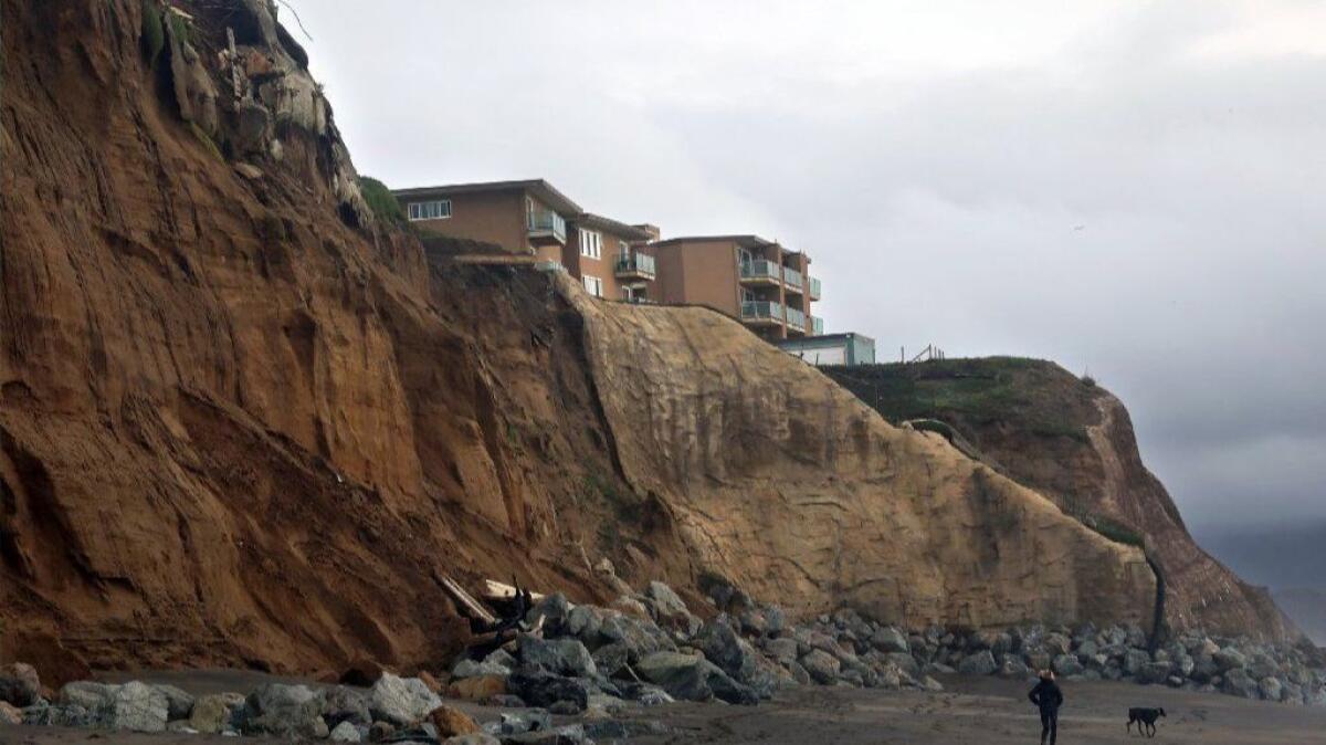On Pacifica Esplanade Dog Beach in January, the remains of an apartment building that fell from the cliffs can be seen along with one still standing. Pacifica, just south of San Francisco, is ground zero for the issue of coastal erosion.