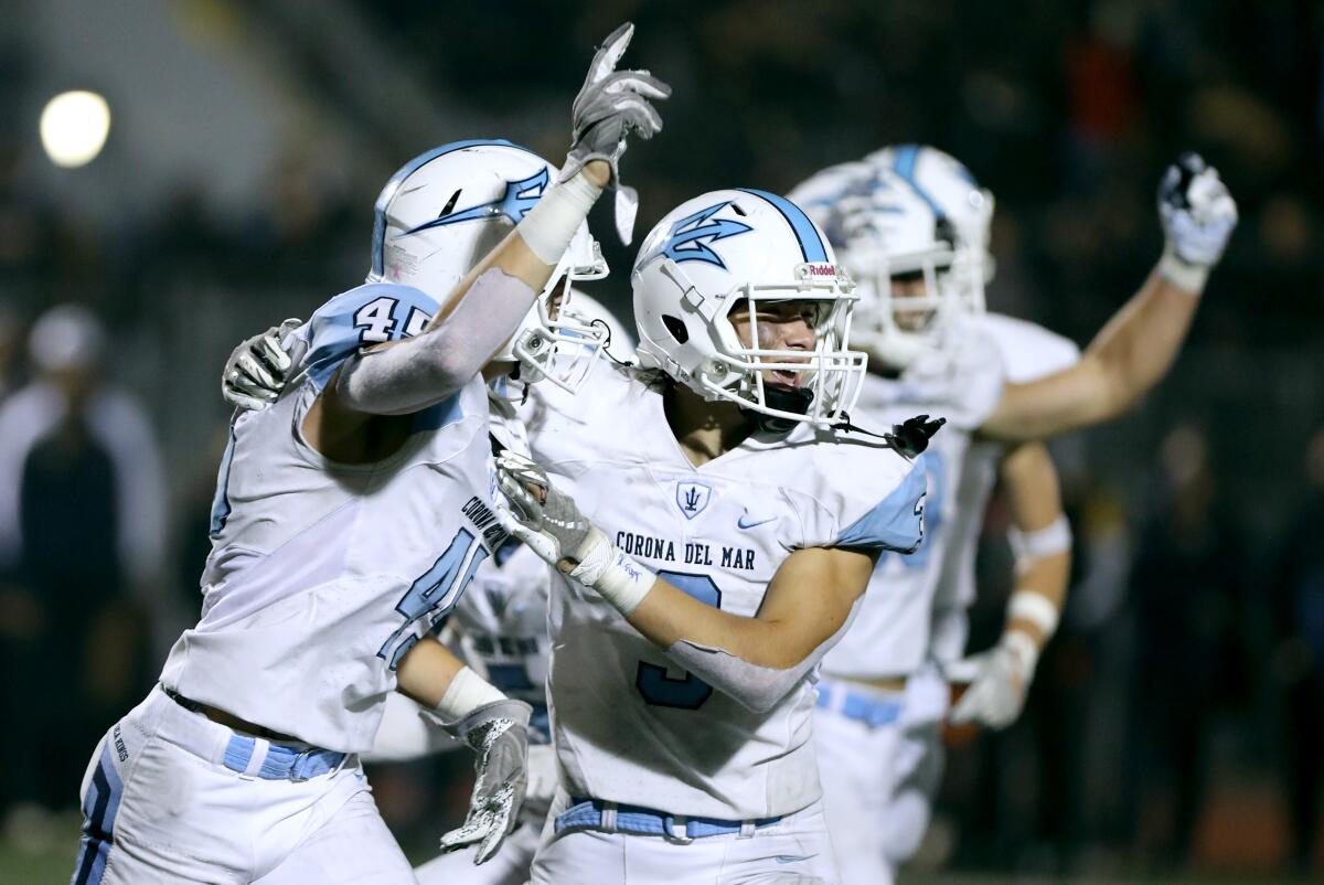 Corona del Mar #45 Ryan Nielsen and #3 Mason Kubichek celebrate Nielsen's QB sack t