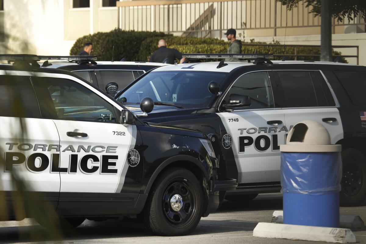 Officers enter the Torrance Police Department's headquarters. 