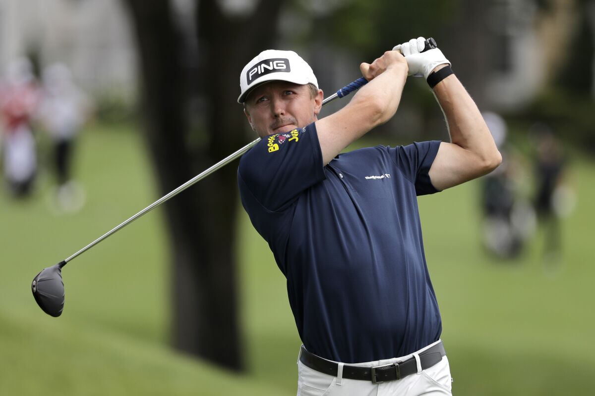 Mackenzie Hughes tees off the third hole during the first round of the Travelers Championship.