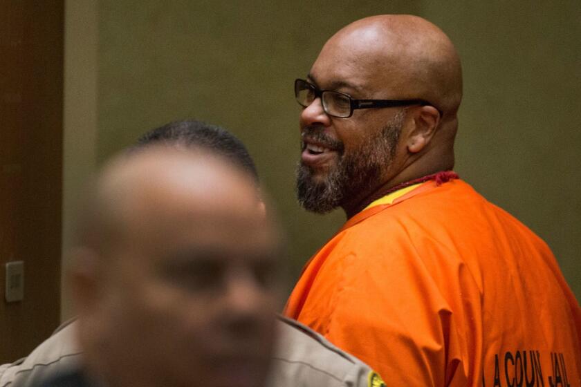 LOS ANGELES, CALIF. -- THURSDAY, AUGUST 3, 2017: Suge Knight smiles at friends and family members in the courtroom following appearance in Los Angeles Superior Court with attorney Matthew Fletcher in Los Angeles, Calif., on Aug. 3, 2017. (Brian van der Brug / Los Angeles Times)