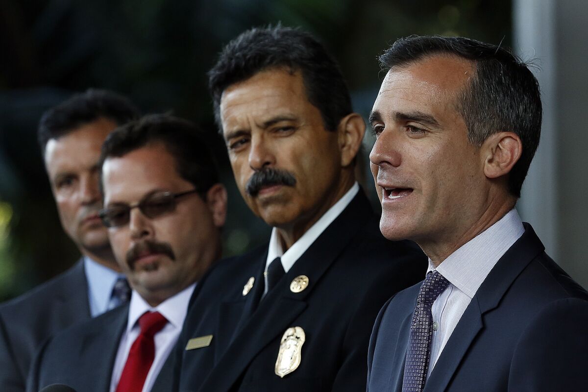 Mayor Eric Garcetti, right, addresses the media outside City Hall East. Beside him is LAFD Fire Chief Ralph Terrazas.