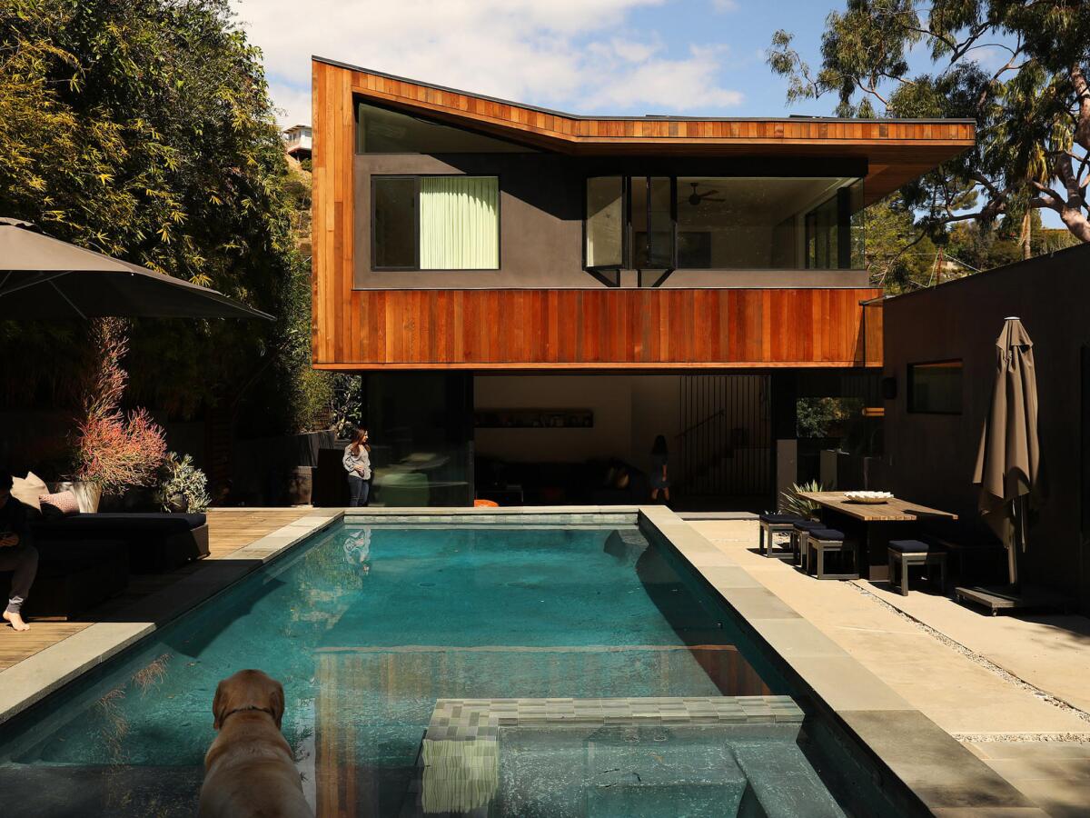 A 1956 ranch home is remade with the addition of a second-floor master bedroom suite clad in cedar — a modern treehouse.