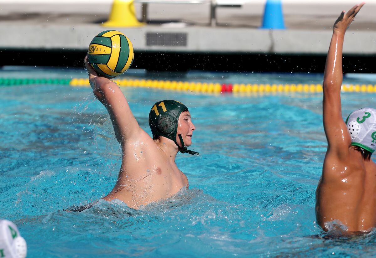 Edison's Thomas Emerson (11) scores against Costa Mesa during the first half in a nonleague boys' water polo game.