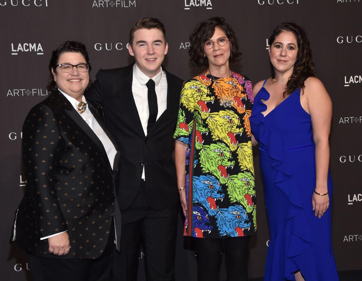 Honoree Catherine Opie, left, with her partner Julie Burleigh, second from right, and family arrive for the 2018 LACMA Art+Film Gala at the Los Angeles County Museum of Art in Los Angeles on Nov. 3.