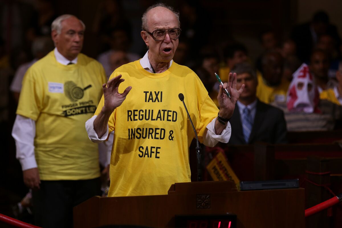 David Shapiro, right, founder of United Independent Taxi (drivers) Inc., expresses discontent with Uber at a Los Angeles City Council meeting in August.