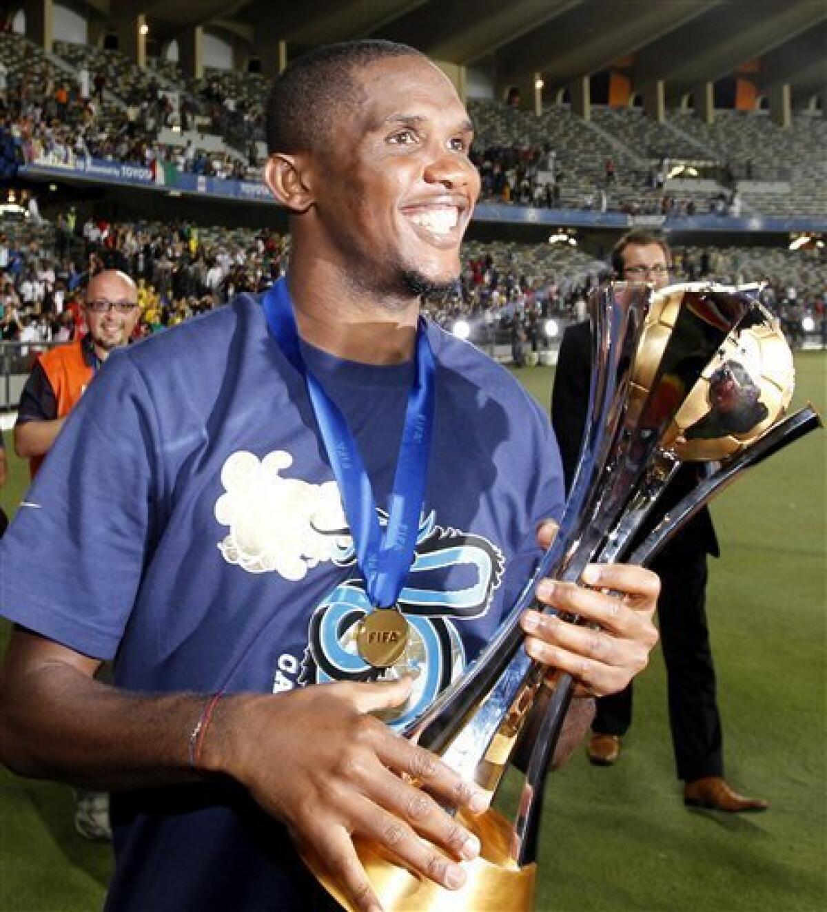 Inter Milan's Samuel Eto'o holds the trophy after winning the Club World Cup final soccer match against TP Mazembe at Zayed sport city in Abu Dhabi, United Arab Emirates, Saturday, Dec. 18, 2010. (AP Photo/Hassan Ammar)