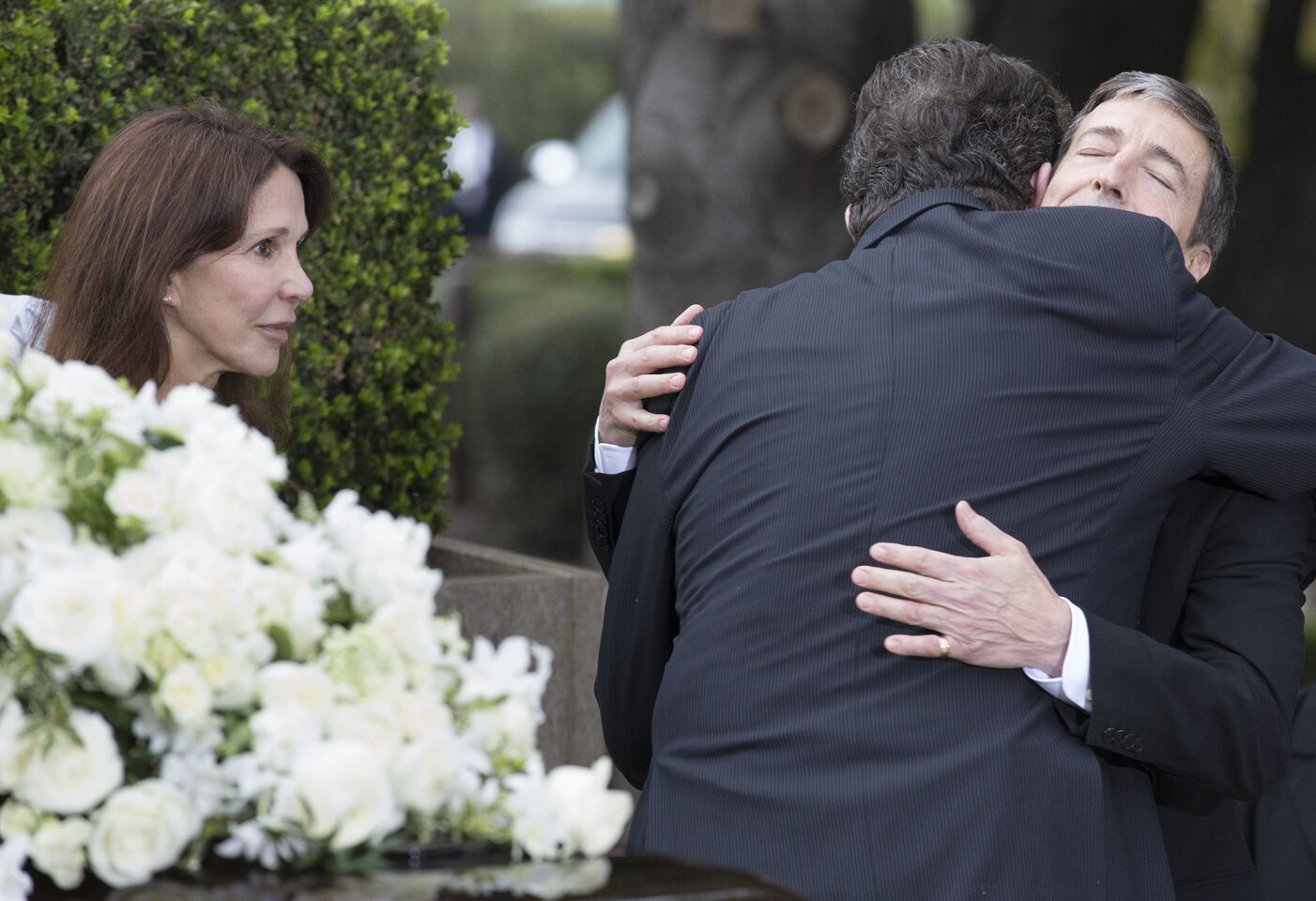 Ron Reagan hugs a mourner as his sister, Patti Davis, left, looks on during funeral services for their mother, Nancy Reagan, at the Ronald Reagan Presidential Library in Simi Valley.