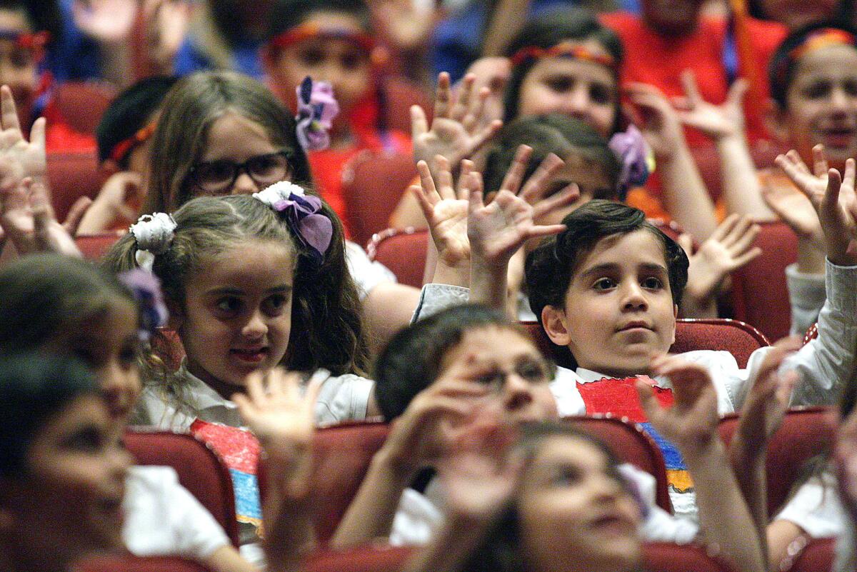Jefferson Elementary School students play Simon Says as they wait for the Armenian Genocide commemoration to start at Glendale High School on Wednesday, April 20, 2016.