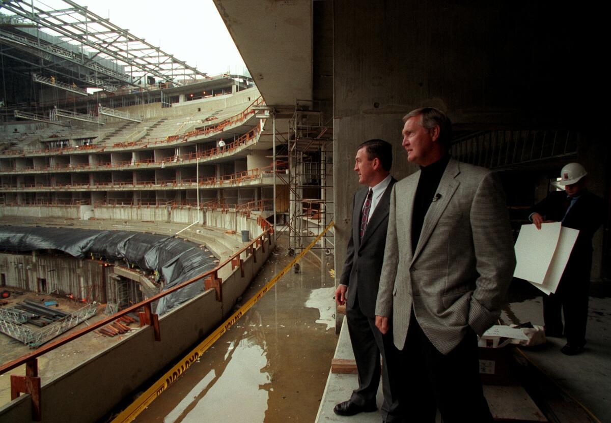 Jerry West, front, and Dave Taylor touring Staples Center in 1999