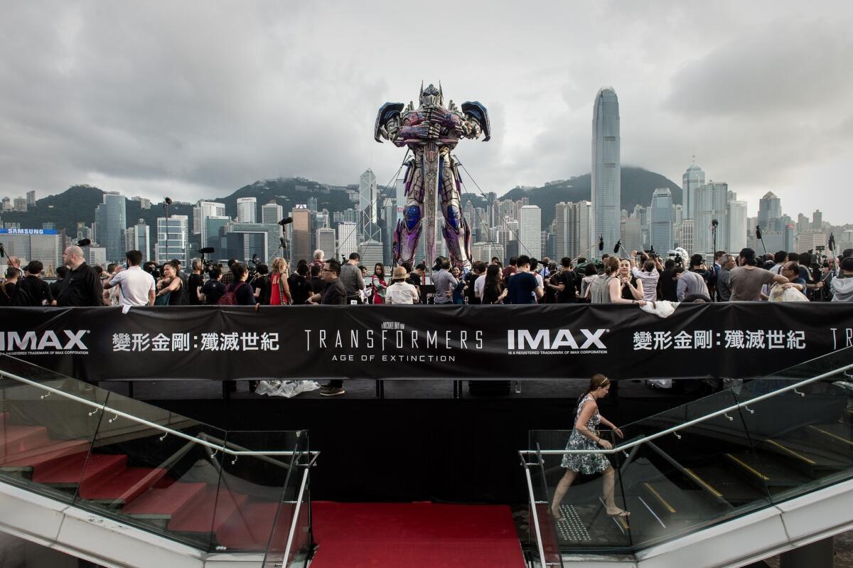 Journalists surround a 20-foot-tall Optimus Prime figure before the world premiere of "Transformers: Age of Extinction" in Hong Kong on June 19.