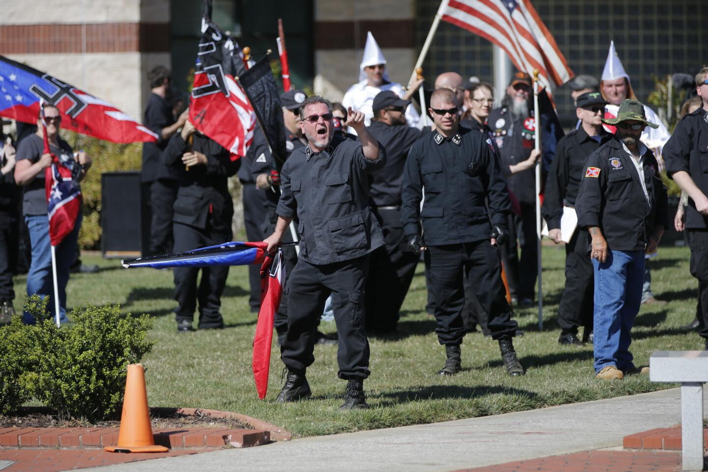 Members of the Ku Klux Klan take part in a "white pride" rally in Rome, Ga., in April. Klan leaders say they believe U.S. politics are going their way, as a nationalist, us-against-them mentality deepens across the nation.