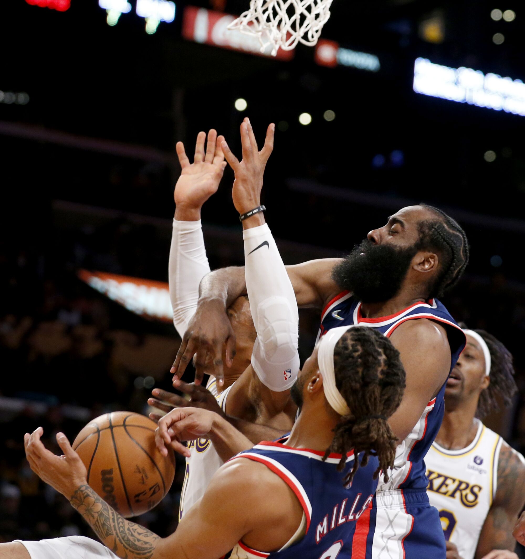 Lakers guard Russell Westbrook has his shot blocked by Brooklyn Nets guard James Harden.