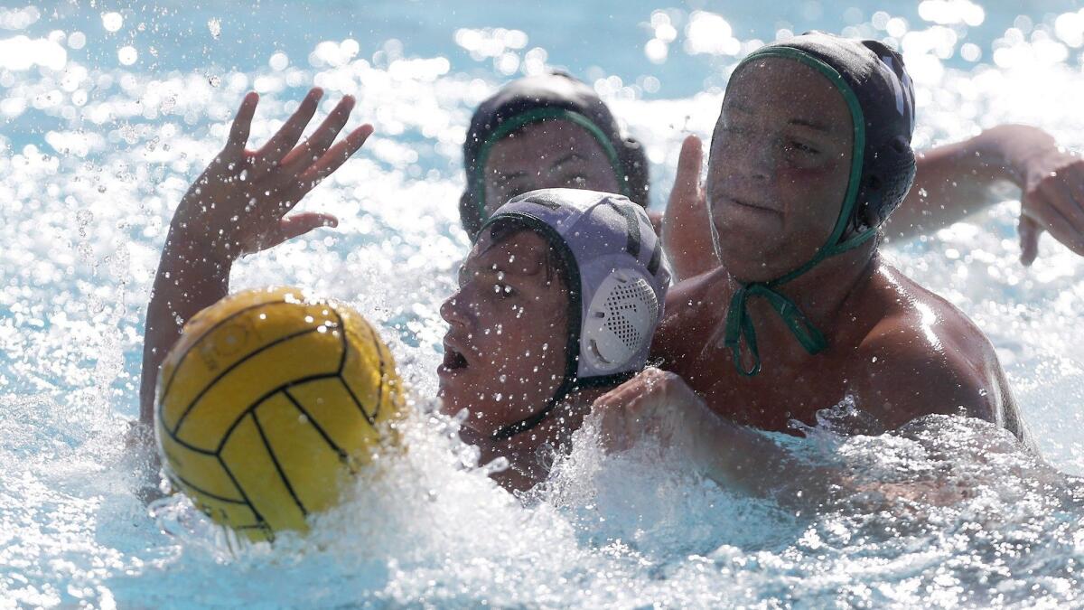 Costa Mesa High's Connor Westbrook, bottom left, battles Sage Hill's Matteo Merage, right, for the ball during the second half of a nonleague game on Tuesday.