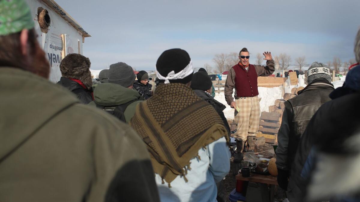 Military veterans are briefed on camps rules and their mission at Oceti Sakowin Camp on the edge of the Standing Rock Sioux Reservation on Saturday outside Cannon Ball, N.D.