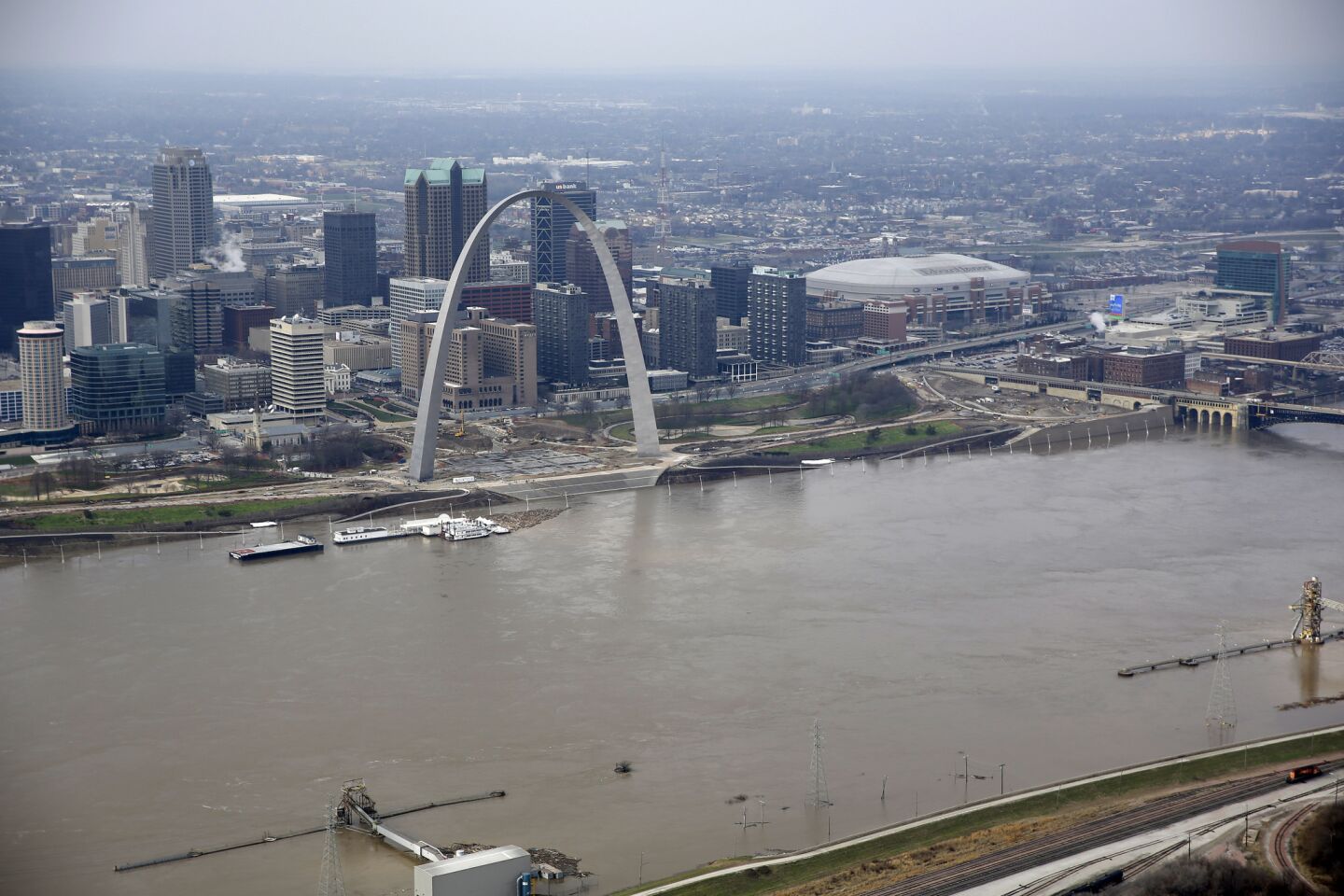 The swollen Mississippi River flows past the Gateway Arch in St. Louis.