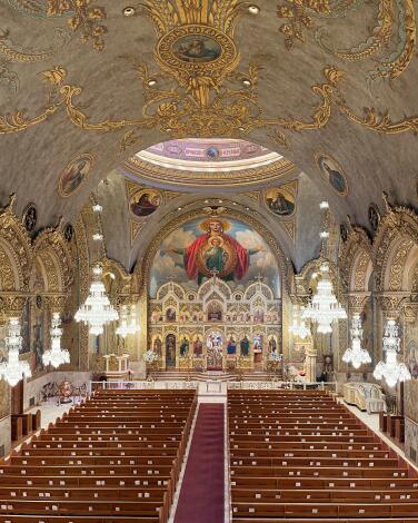 A large painting of the Virgin Mary looks over the pews at St. Sophia Greek Orthodox Cathedral.