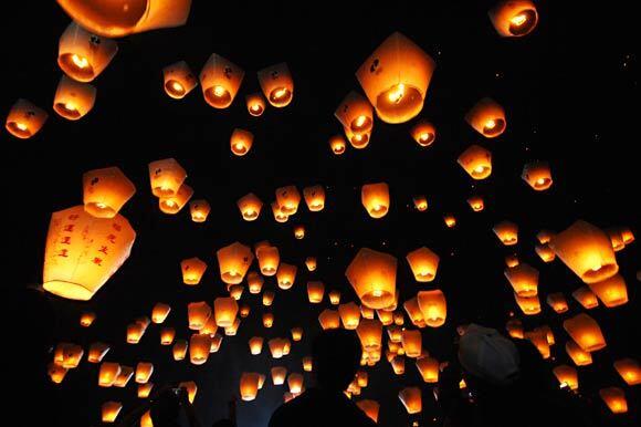 People release sky lanterns in Pingxi, a town in Taiwan near Taipei. The Pingxi Sky Lantern Festival is one of the events connected with the Taiwan Lantern Festival, which has been held for over 20 years. Next year's lantern festival will take place Feb. 6.