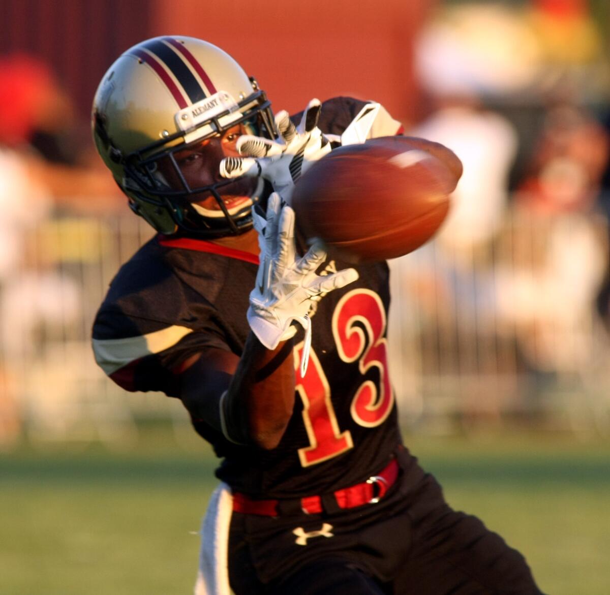 Alemany's Desean Holmes catches a pass prior to the start of Friday's game against Narbonne.