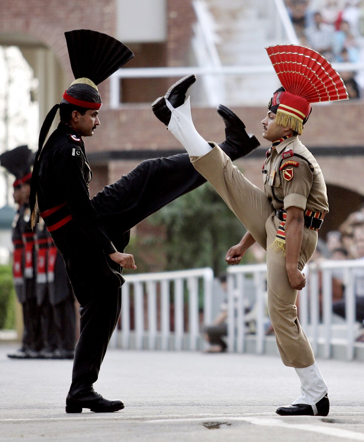 An Indian Border Security Force soldier, right, and Pakistani Ranger soldier conduct an elaborate march during the daily flag ceremony at the Wagah border post.