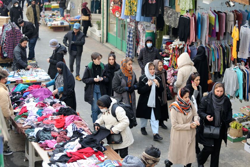 Iranian women shop at the bazaar of Tajrish in northern Tehran on January 25, 2023. - The EU and Britain slapped yesterday another round of sanctions on Iran, which has been rocked by protests since the September 16 death of Amini, a 22-year-old Iranian Kurd who had been arrested for allegedly breaching the country's strict dress code for women. The Islamic republic Iran vowed it will respond, warning of tit-for-tat measures. (Photo by ATTA KENARE / AFP) (Photo by ATTA KENARE/AFP via Getty Images)
