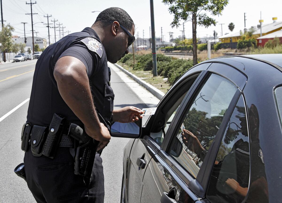 Glendale Police officer Aaron Zeigler pulls over a driver who was using a cell phone while driving on San Fernando Rd. in Glendale on Thursday, April 3, 2014.