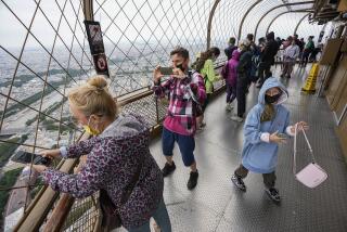 FILE - In this Friday, July 16, 2021 file photo, visitors enjoy the view from top of the Eiffel Tower in Paris. The European Union is expected to recommend that its member states reinstate restrictions on tourists from the U.S. because of rising coronavirus infection levels in the country, EU diplomats said Monday, Aug. 30. (AP Photo/Michel Euler, File)