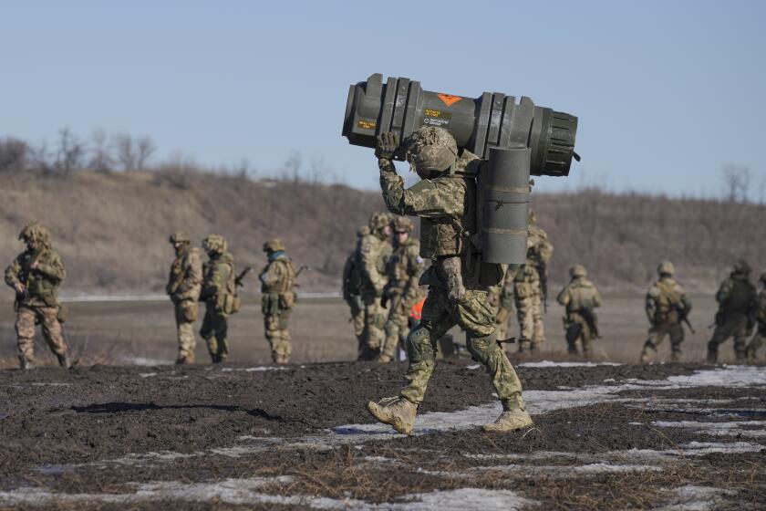 A Ukrainian serviceman carries an NLAW anti-tank weapon during an exercise in the Joint Forces Operation, in the Donetsk region, eastern Ukraine, Tuesday, Feb. 15, 2022. While the U.S. warns that Russia could invade Ukraine any day, the drumbeat of war is all but unheard in Moscow, where pundits and ordinary people alike don't expect President Vladimir Putin to launch an attack on its ex-Soviet neighbor. (AP Photo/Vadim Ghirda)