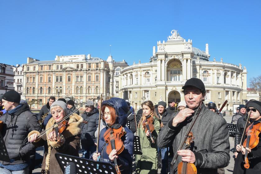 ODESSA, UKRAINE - MARCH 12: The symphony orchestra and choir of the Odessa National Academic Opera and Ballet Theater perform the National Anthem of Ukraine and a number of famous musical works during an event in support of no-fly zone in Ukraine and against war near Odessa Opera Theater in Odessa, Ukraine on March 12, 2022. (Photo by Maksym Voitenko/Anadolu Agency via Getty Images)