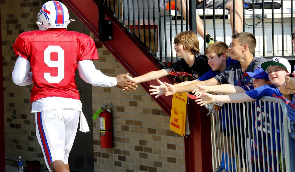 Bills quarterback Thad Lewis (9) high-fives young fans during training camp on Tuesday in Pittsford, N.Y.