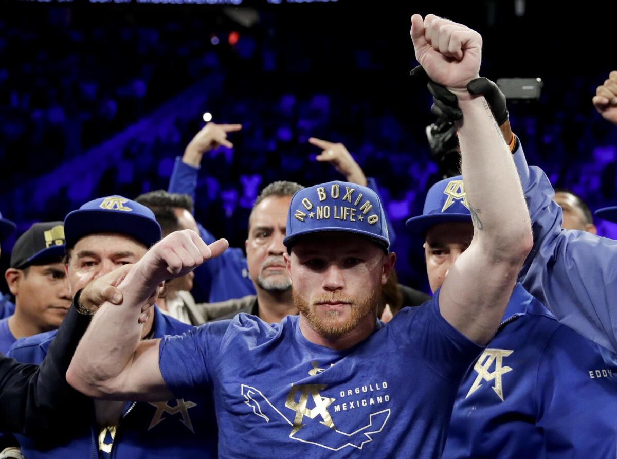 Canelo Alvarez celebrates with his team after defeating Julio Cesar Chavez Jr. by unanimous decision.